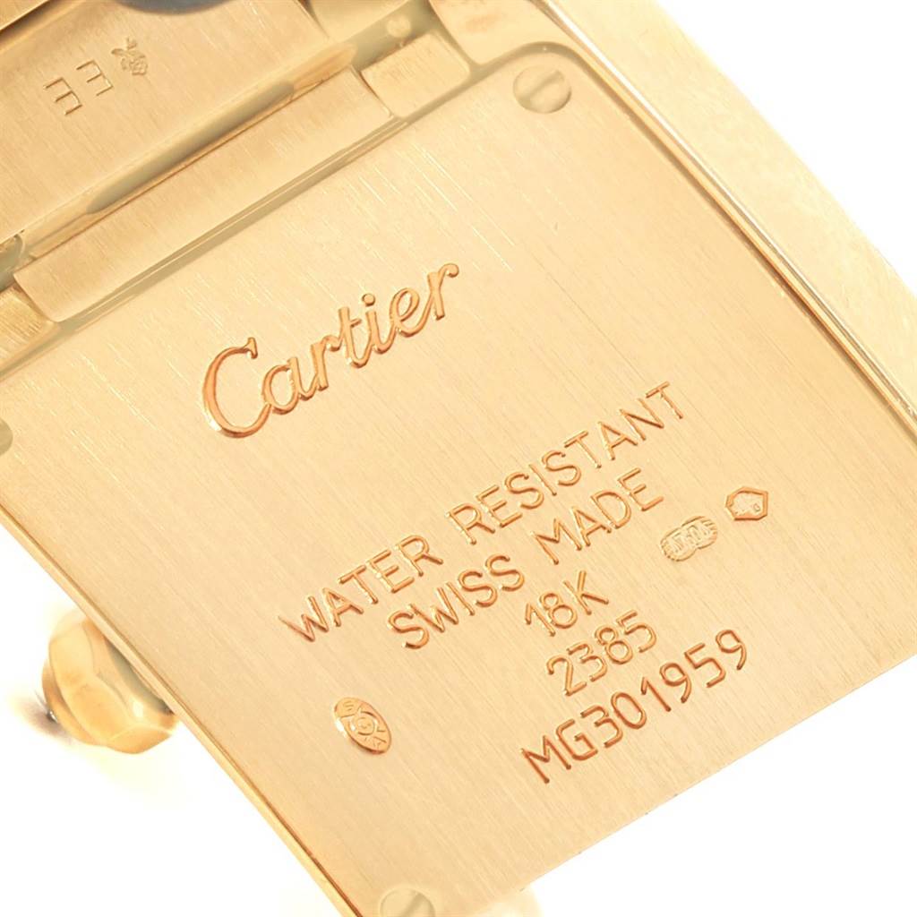 This image shows a close-up of the back case of a Cartier Tank Francaise WE1001R8 Women's Yellow Gold Silver Dial WE1001R8 Women's Yellow Gold Silver Dial watch, highlighting the brand and model information.