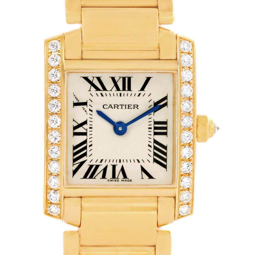 The image shows a close-up of a Cartier Tank Francaise WE1001R8 Women's Yellow Gold Silver Dial WE1001R8 Women's Yellow Gold Silver Dial watch face and part of the gold bracelet.
