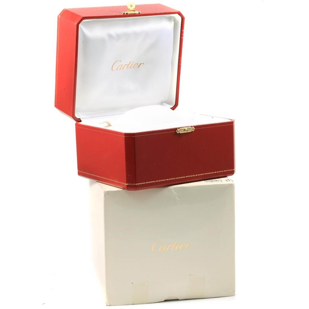 This image shows an open red Cartier box with a white interior, sitting atop a white paper box for the Tank Française model.