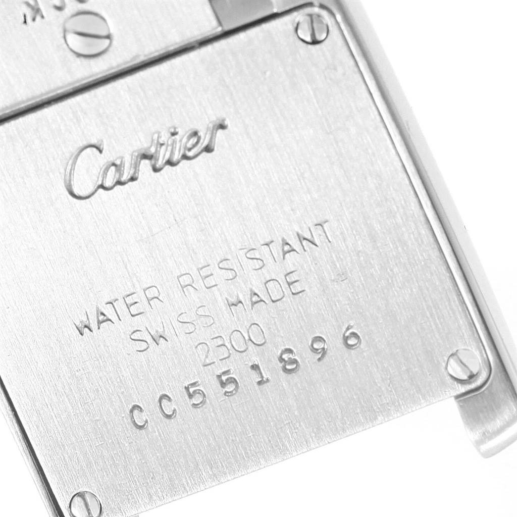 The image shows the engraved back casing of a Tank Francaise model by Cartier, highlighting brand markings and serial numbers.
