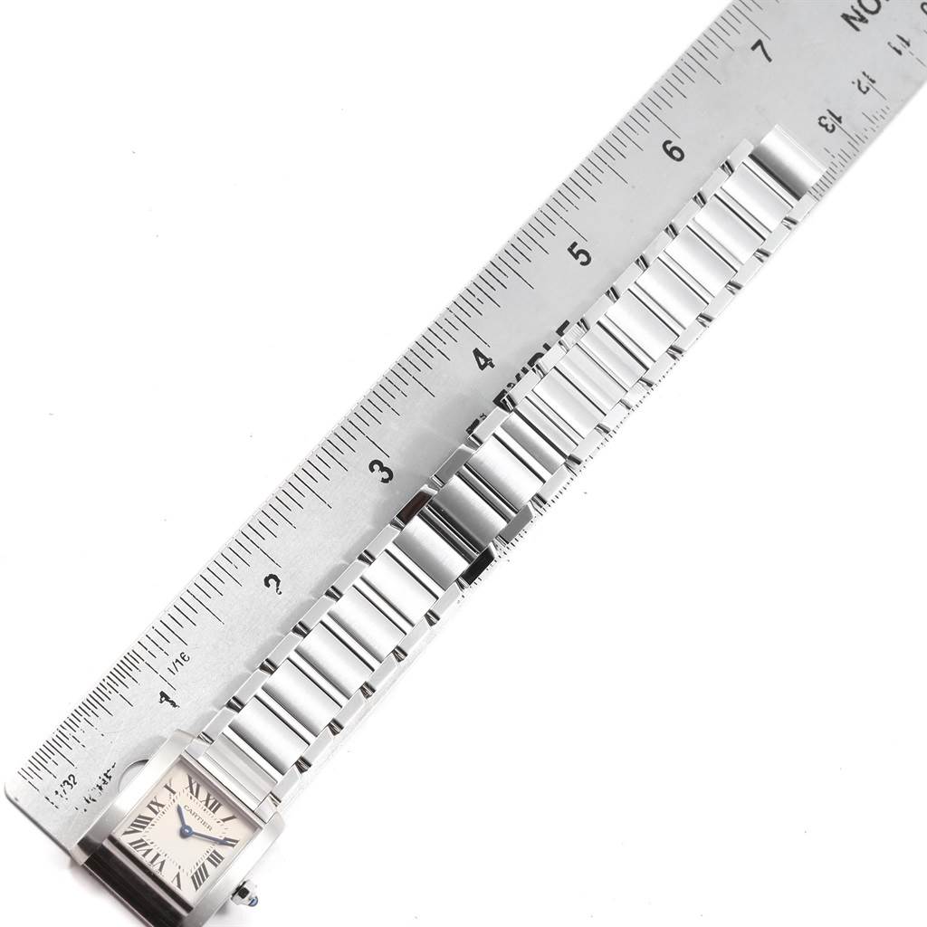 The image shows a top view of a Cartier Tank Francaise W51008Q3 Women's Stainless Steel Silver Dial W51008Q3 Women's Stainless Steel Silver Dial watch with its face and metal band partially measured against a ruler.
