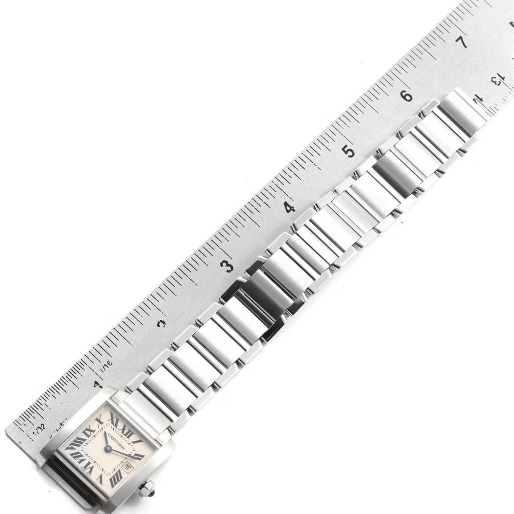 The image shows the Cartier Tank Francaise W51011Q3 Women's Stainless Steel Silver Dial W51011Q3 Women's Stainless Steel Silver Dial watch lying flat, with its bracelet aligned next to a ruler for measurement.