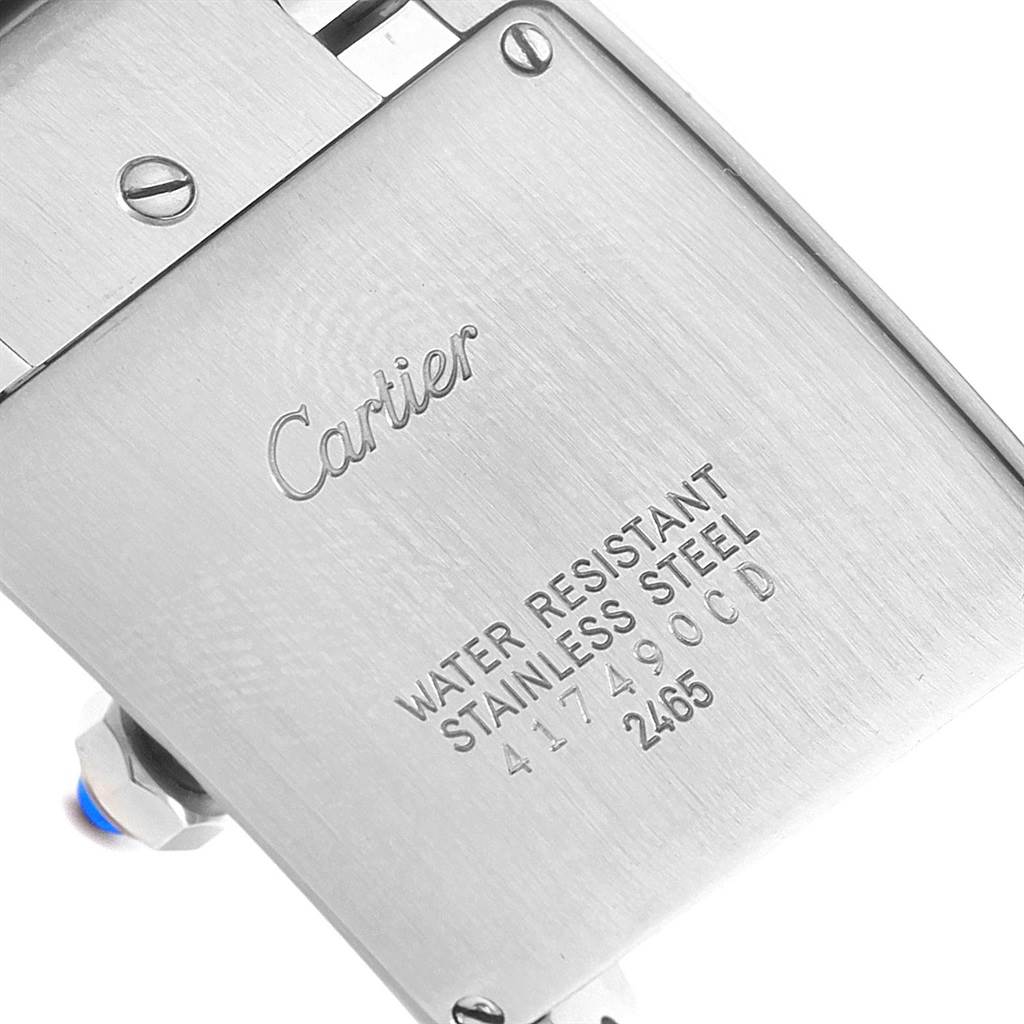 The image shows the stainless steel case back of the Tank Francaise model by Cartier, displaying engraved details.