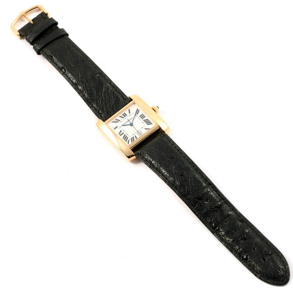 The image shows a top-down view of a Cartier Tank Française watch, highlighting its black leather strap and square dial.