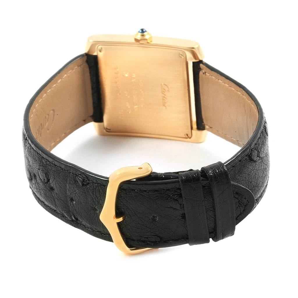 The image shows the back view of a Cartier Tank Francaise W5000156 Yellow Gold Silver Dial W5000156 Yellow Gold Silver Dial watch, highlighting its leather strap and clasp.