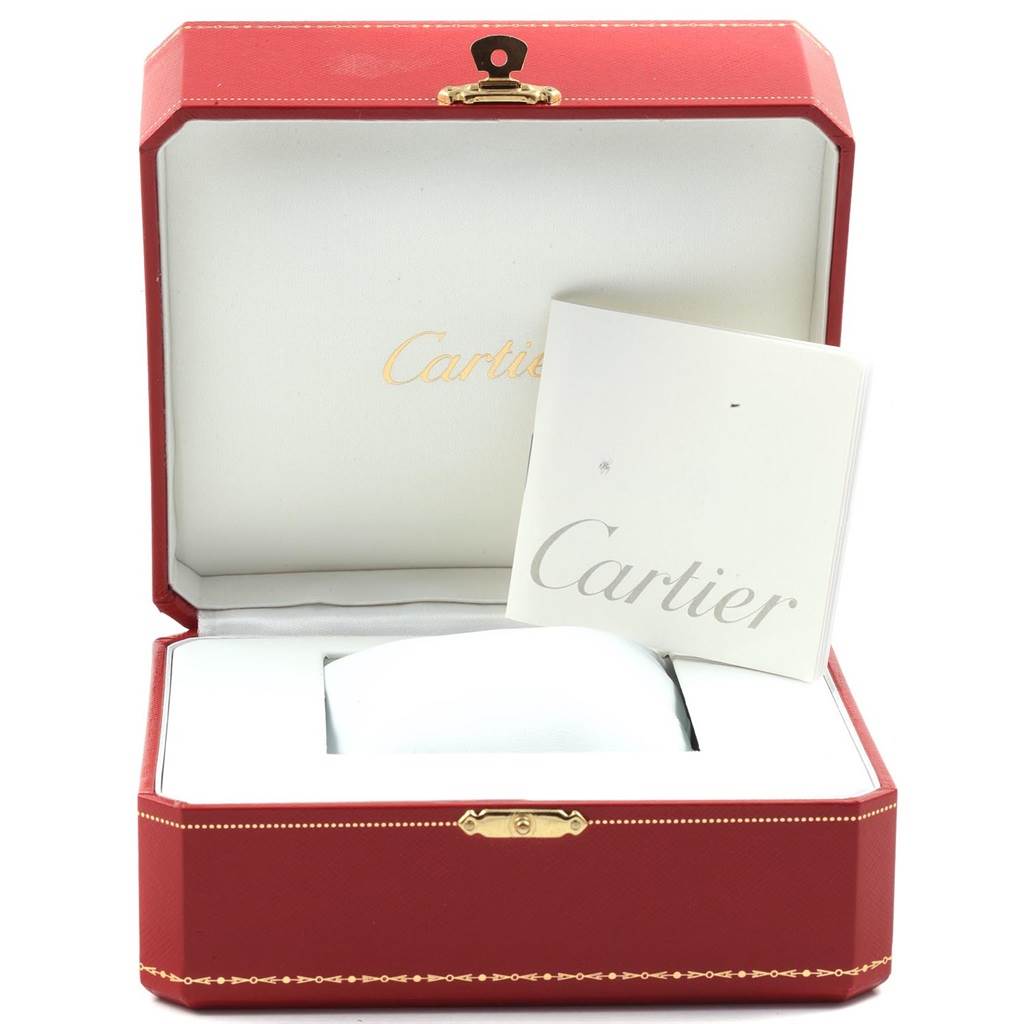 The image shows the packaging and manual for the Cartier Tank Francaise W5000156 Yellow Gold Silver Dial W5000156 Yellow Gold Silver Dial watch, featuring a red box and Cartier booklet.