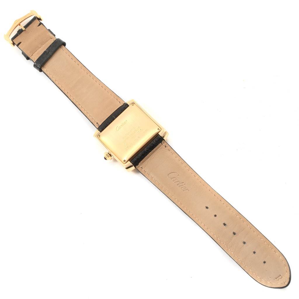 The image shows the back of a Cartier Tank Française watch, including the leather strap and gold case.