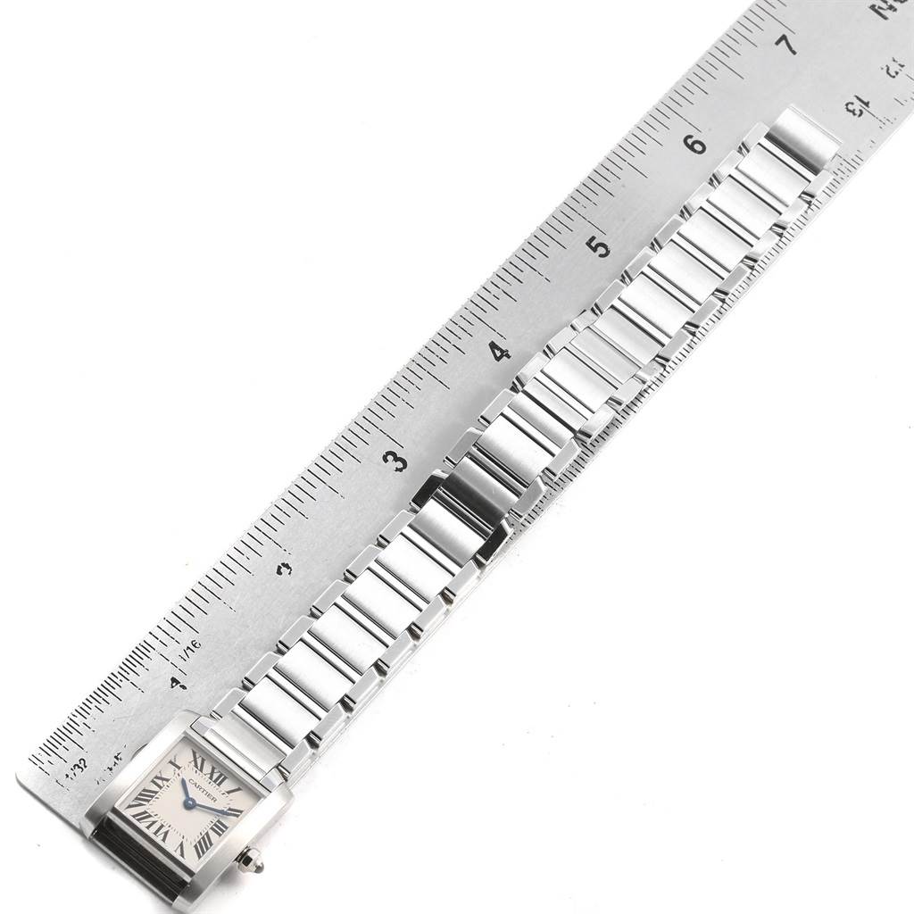The Cartier Tank Francaise W51008Q3 Women's Stainless Steel Silver Dial W51008Q3 Women's Stainless Steel Silver Dial watch is shown from a top-down angle, with its metal bracelet aligned beside a ruler.
