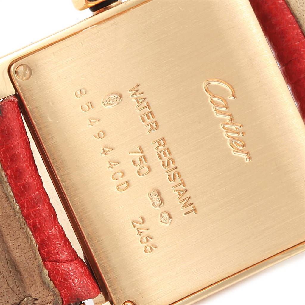 The image shows the backplate of a Cartier Tank Francaise W50014N2 Women's Yellow Gold Silver Dial W50014N2 Women's Yellow Gold Silver Dial watch along with the leather strap attachment.