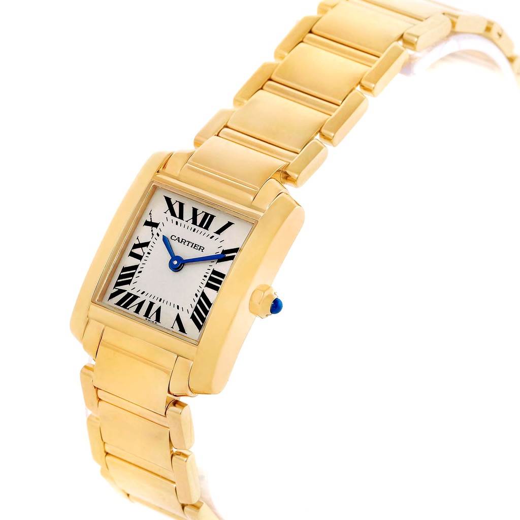 The Cartier Tank Française watch is shown at a slight angle, showcasing its gold bracelet, rectangular face, and blue cabochon crown.