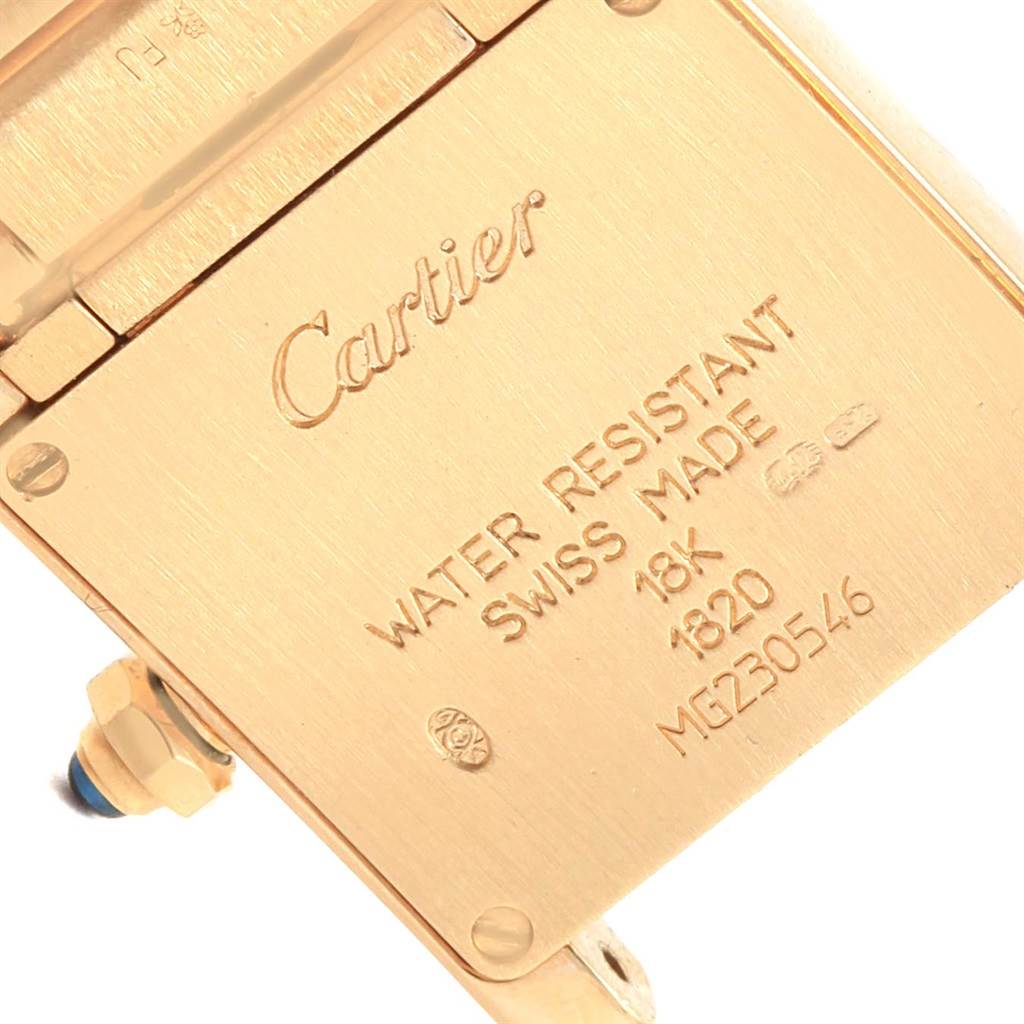 This image shows the back case of the Cartier Tank Francaise W50002N2 Women's Yellow Gold Silver Dial W50002N2 Women's Yellow Gold Silver Dial watch with engraved details on gold.