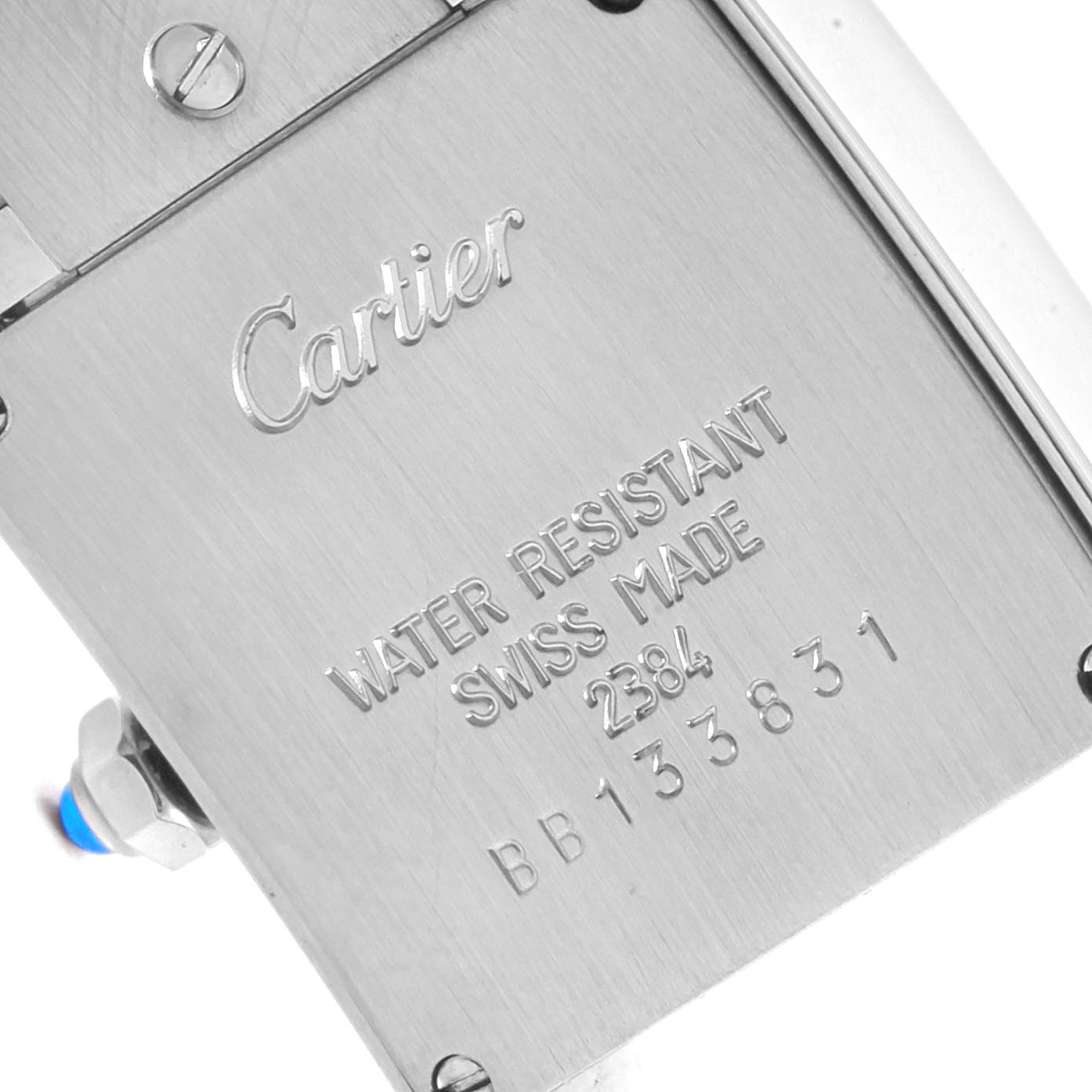 This is a close-up of the back case of a Tank Francaise watch by Cartier, showing engraved brand information and serial numbers.