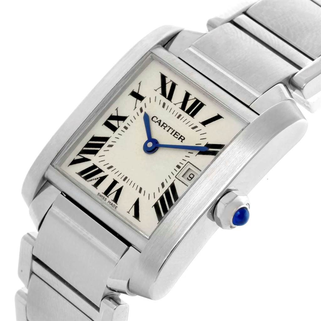 The image shows a close-up angled view of the Tank Francaise watch by Cartier, featuring the face, bezel, part of the bracelet, and crown with a blue cabochon.