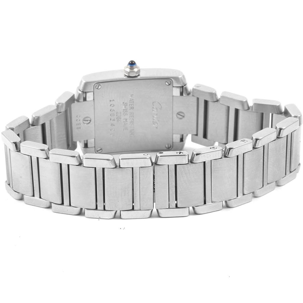 The image shows the back view of a Cartier Tank Française watch, highlighting its metal bracelet and case back.