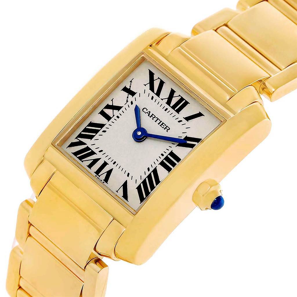 This image shows a Cartier Tank Francaise W50002N2 Women's Yellow Gold Silver Dial W50002N2 Women's Yellow Gold Silver Dial watch at a tilted angle, highlighting its gold bracelet, face, and blue hands.