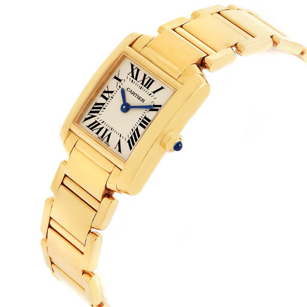 This image shows the Cartier Tank Francaise W50002N2 Women's Yellow Gold Silver Dial W50002N2 Women's Yellow Gold Silver Dial watch at an angle highlighting the face, crown, and part of the gold bracelet.
