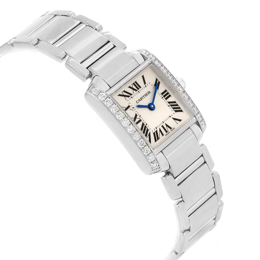 The image shows a side angle of a Cartier Tank Française watch, highlighting its rectangular face, Roman numeral dial, and linked bracelet.