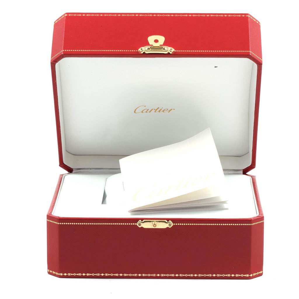 This image shows an open Cartier watch box for the Tank Francaise model, featuring red exterior and documentation.