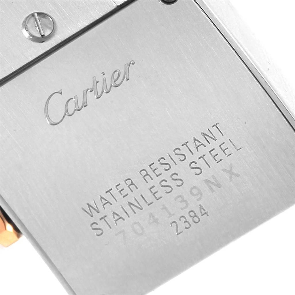 The image shows a close-up of the case back of a Cartier Tank Française watch, highlighting the engraving and screws.