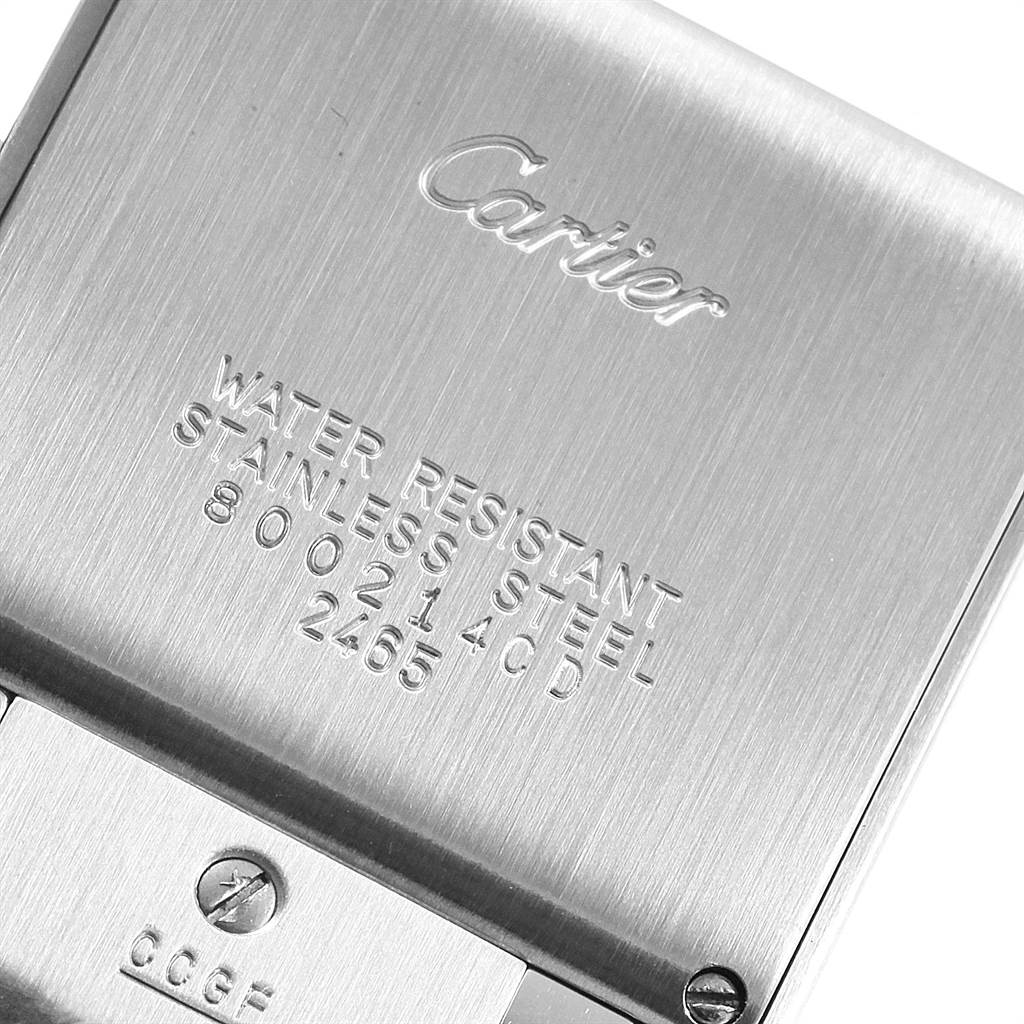 This is a close-up of the back case of a Cartier Tank Francaise W51011Q3 Women's Stainless Steel Silver Dial W51011Q3 Women's Stainless Steel Silver Dial watch, showing its engravings and screws.