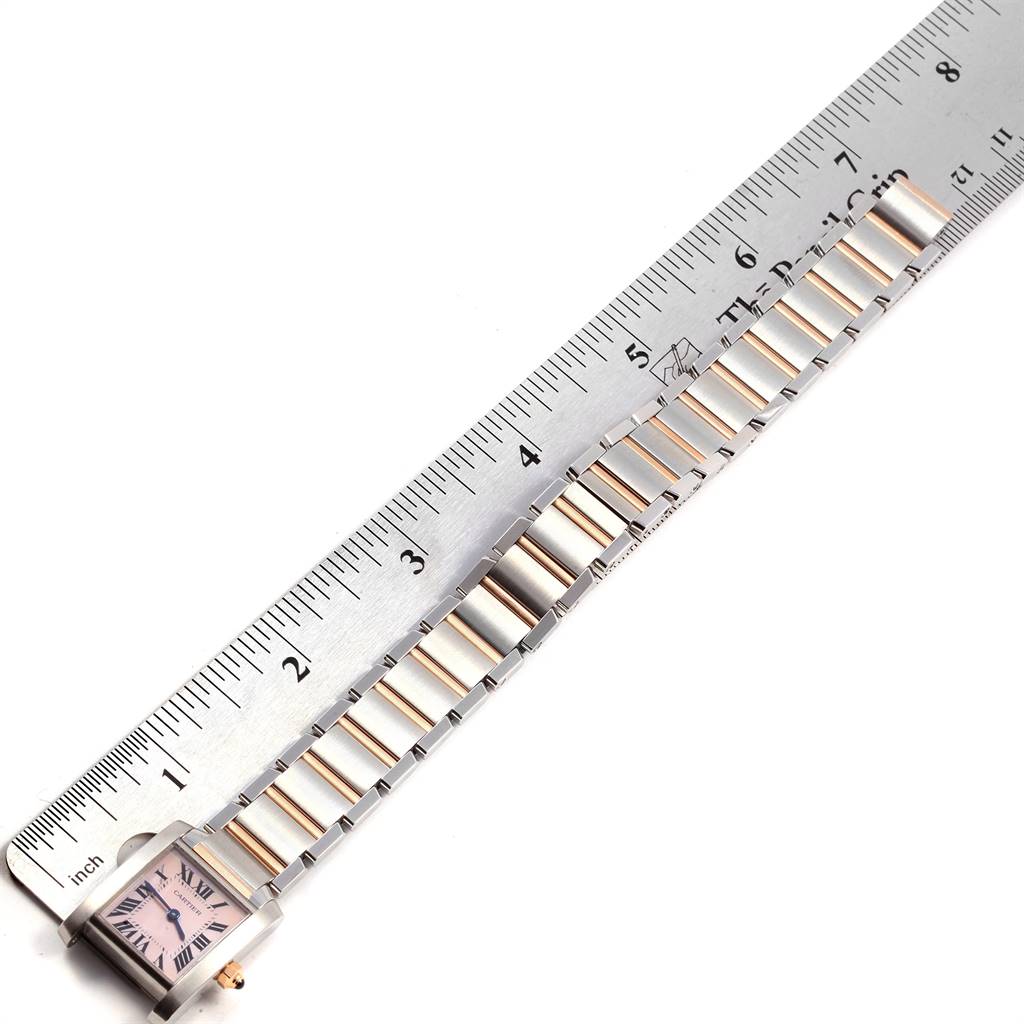 The image shows a Cartier Tank Francaise W51027Q4 Women's Steel and Gold (two tone) Mother of Pearl Dial W51027Q4 Women's Steel and Gold (two tone) Mother of Pearl Dial watch lying flat next to a ruler, focusing on the face and the bracelet.