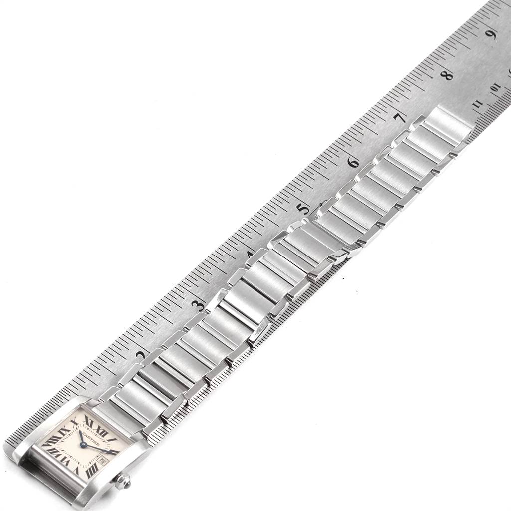 The Cartier Tank Francaise W51011Q3 Women's Stainless Steel Silver Dial W51011Q3 Women's Stainless Steel Silver Dial watch is shown from the top, displaying the face and full length of the metallic band alongside a ruler.