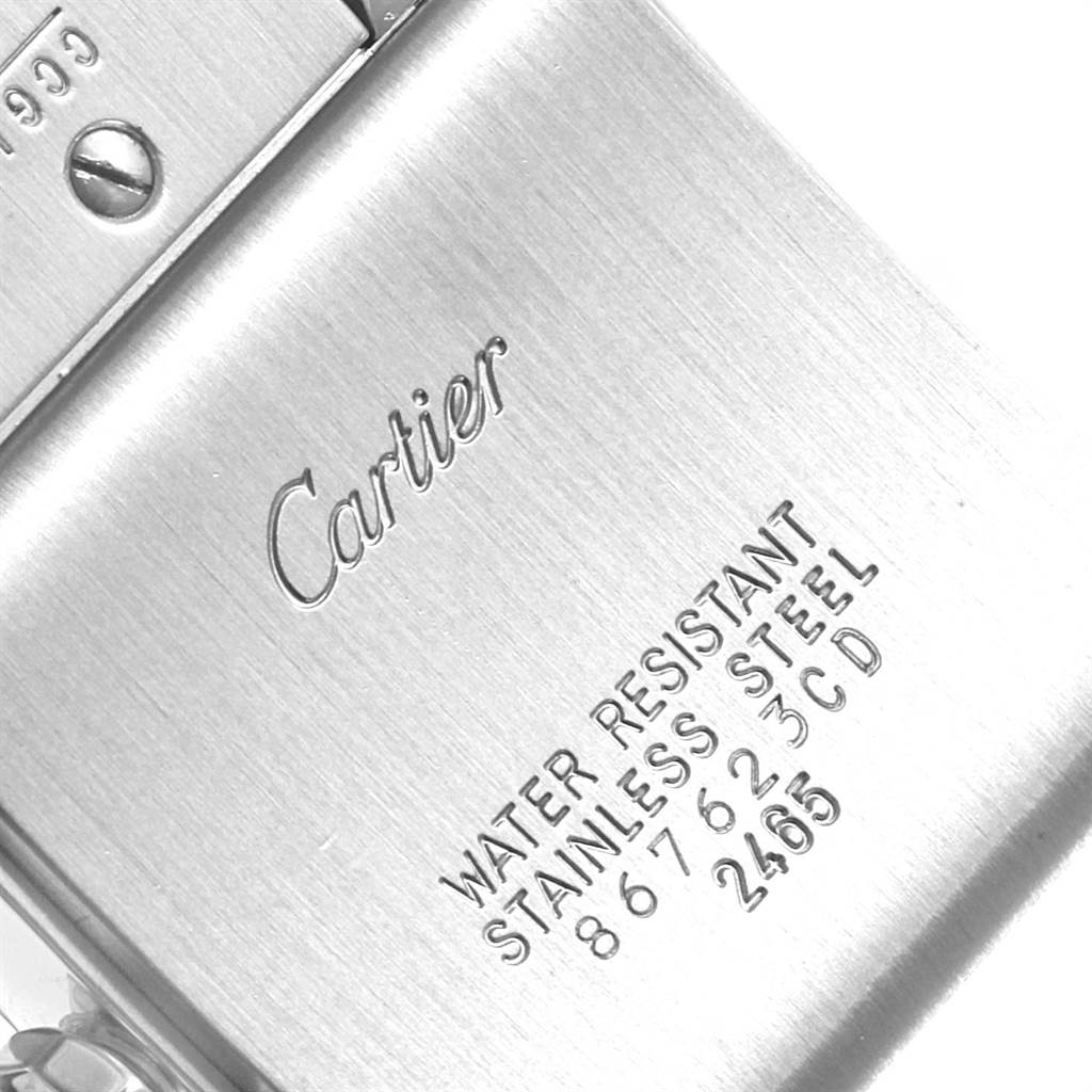 This image shows the back of the Tank Française by Cartier, displaying the brand name and details about water resistance and material.