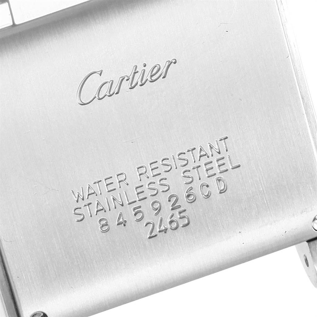 This image shows a close-up of the back case of a Cartier Tank Francaise W51011Q3 Women's Stainless Steel Silver Dial W51011Q3 Women's Stainless Steel Silver Dial watch, displaying the brand name and material specifications.
