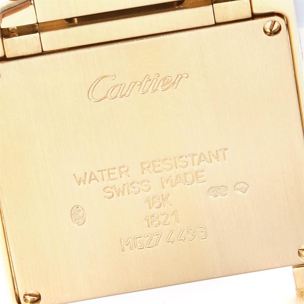 The image shows the back case of a Cartier Tank Francaise W50003N2 Women's Yellow Gold Silver Dial W50003N2 Women's Yellow Gold Silver Dial watch, highlighting engraved information about water resistance and material.