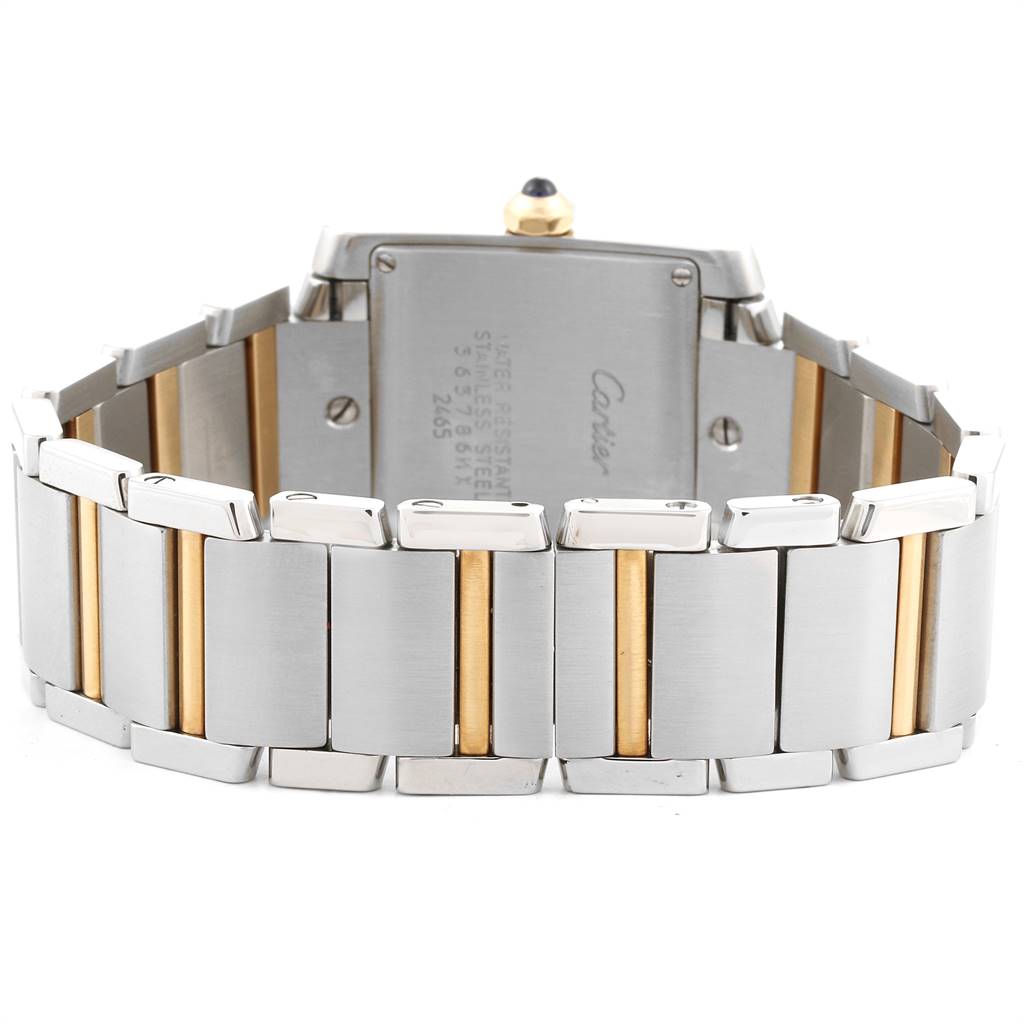 The image shows the back and bracelet of a Cartier Tank Française watch, featuring stainless steel and gold elements.