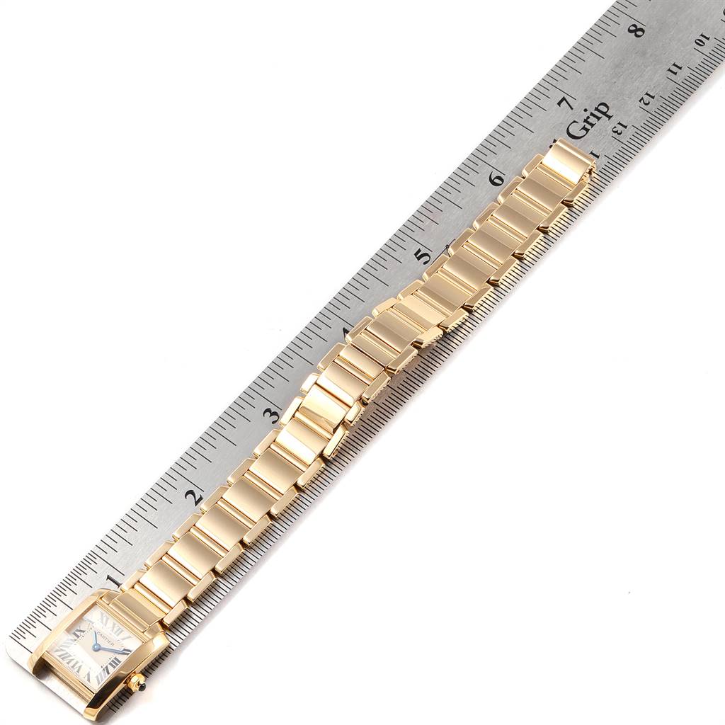 The image shows the entire Tank Française watch by Cartier, positioned alongside a ruler for scale.