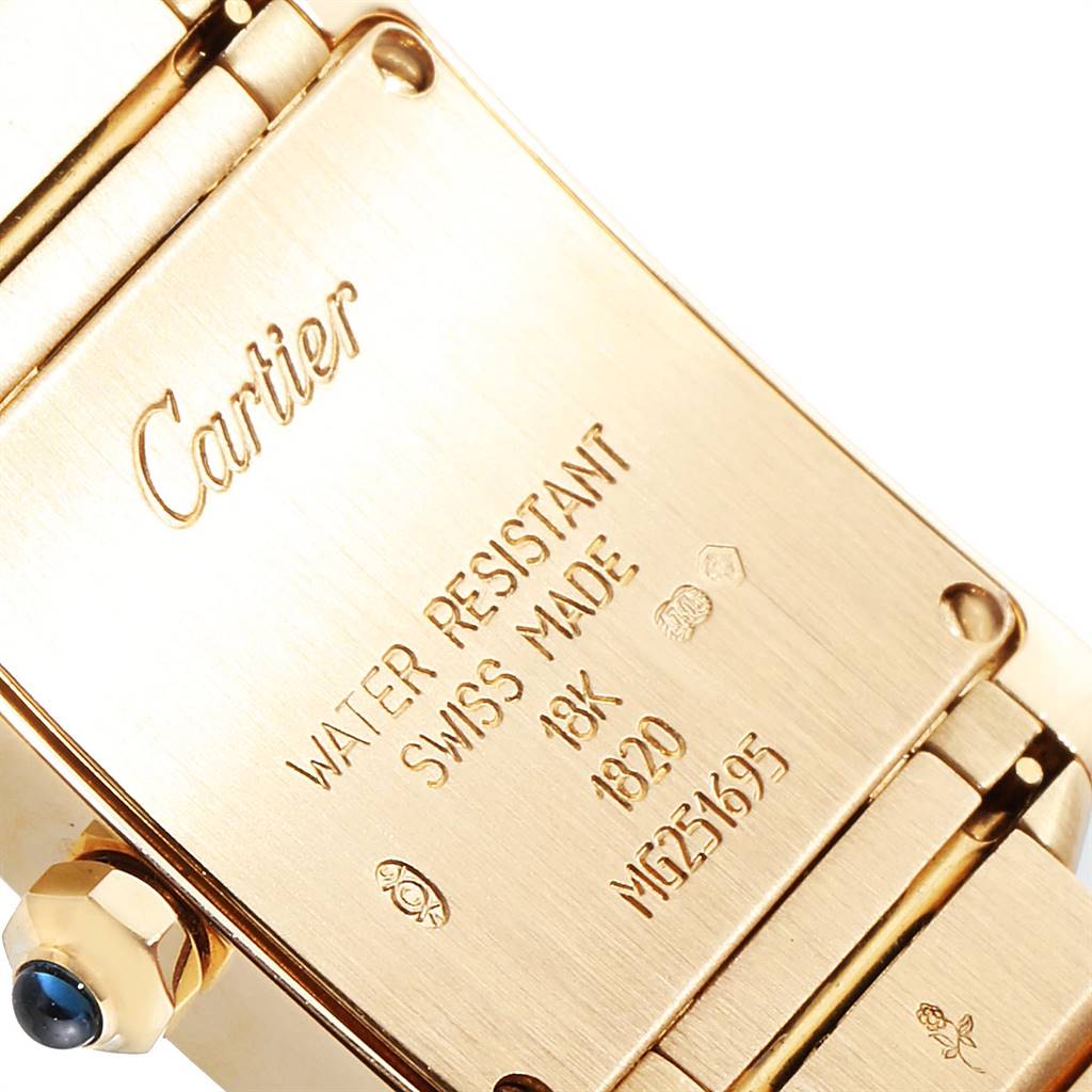 The image shows the back case and part of the bracelet of a Cartier Tank Francaise W50002N2 Women's Yellow Gold Silver Dial W50002N2 Women's Yellow Gold Silver Dial watch at a close-up angle.