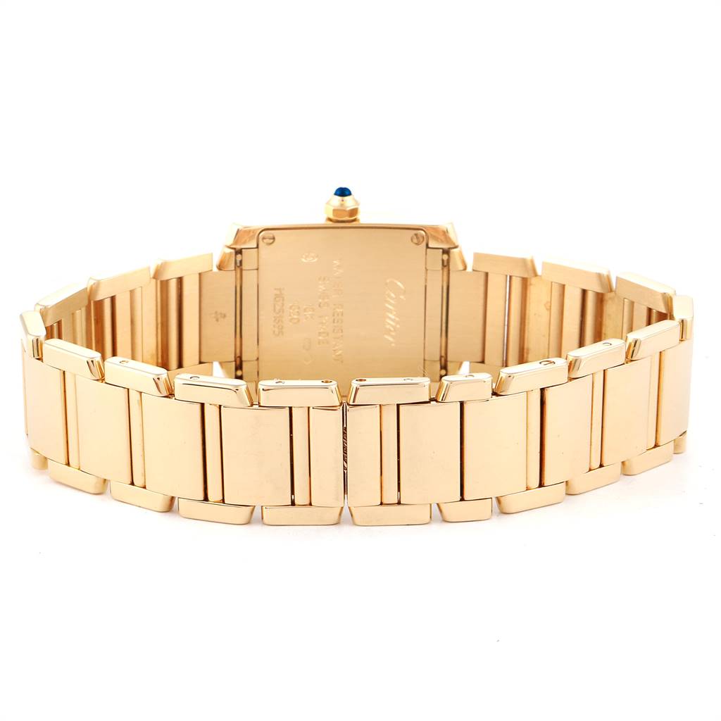 This image shows the back and bracelet of a Cartier Tank Francaise W50002N2 Women's Yellow Gold Silver Dial W50002N2 Women's Yellow Gold Silver Dial watch at an angle focusing on the case back.