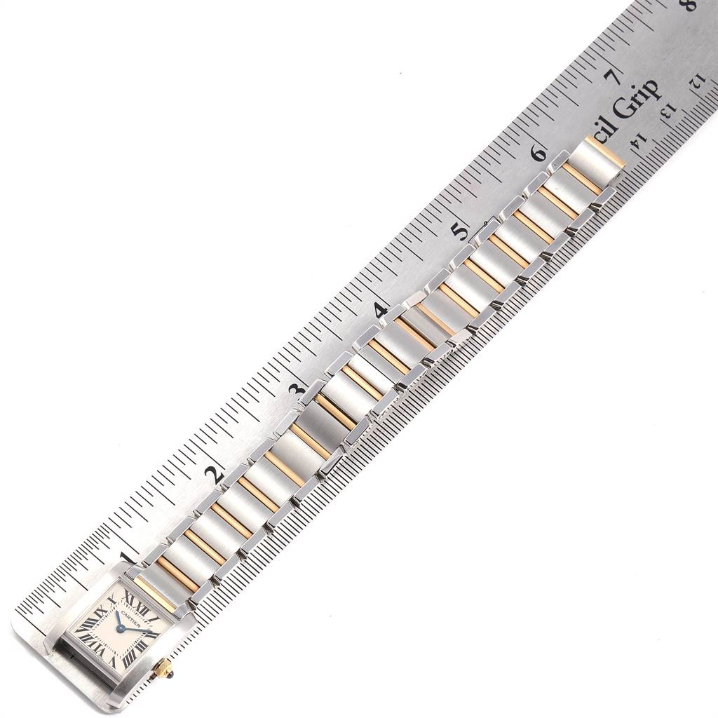 The image shows a Cartier Tank Francaise W51007Q4 Women's Steel and Gold (two tone) Silver Dial W51007Q4 Women's Steel and Gold (two tone) Silver Dial watch laid next to a ruler, displaying the face and bracelet links.