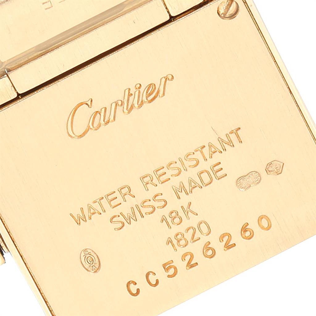 The image shows the back casing of a Cartier Tank Francaise W50002N2 Women's Yellow Gold Silver Dial W50002N2 Women's Yellow Gold Silver Dial watch, featuring engraved branding and specifications.