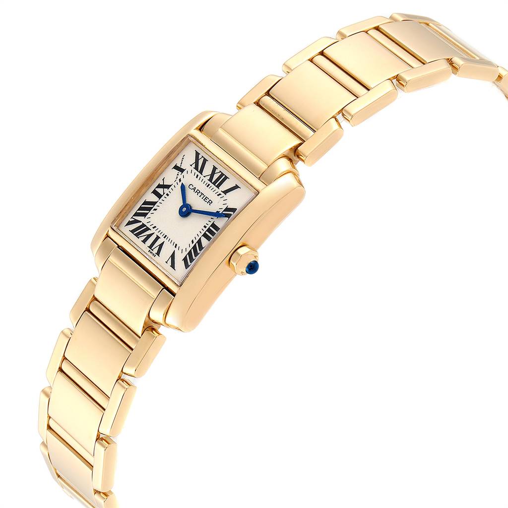 The image shows an angled view of the Tank Française watch by Cartier, highlighting its gold bracelet, case, and blue sapphire crown.
