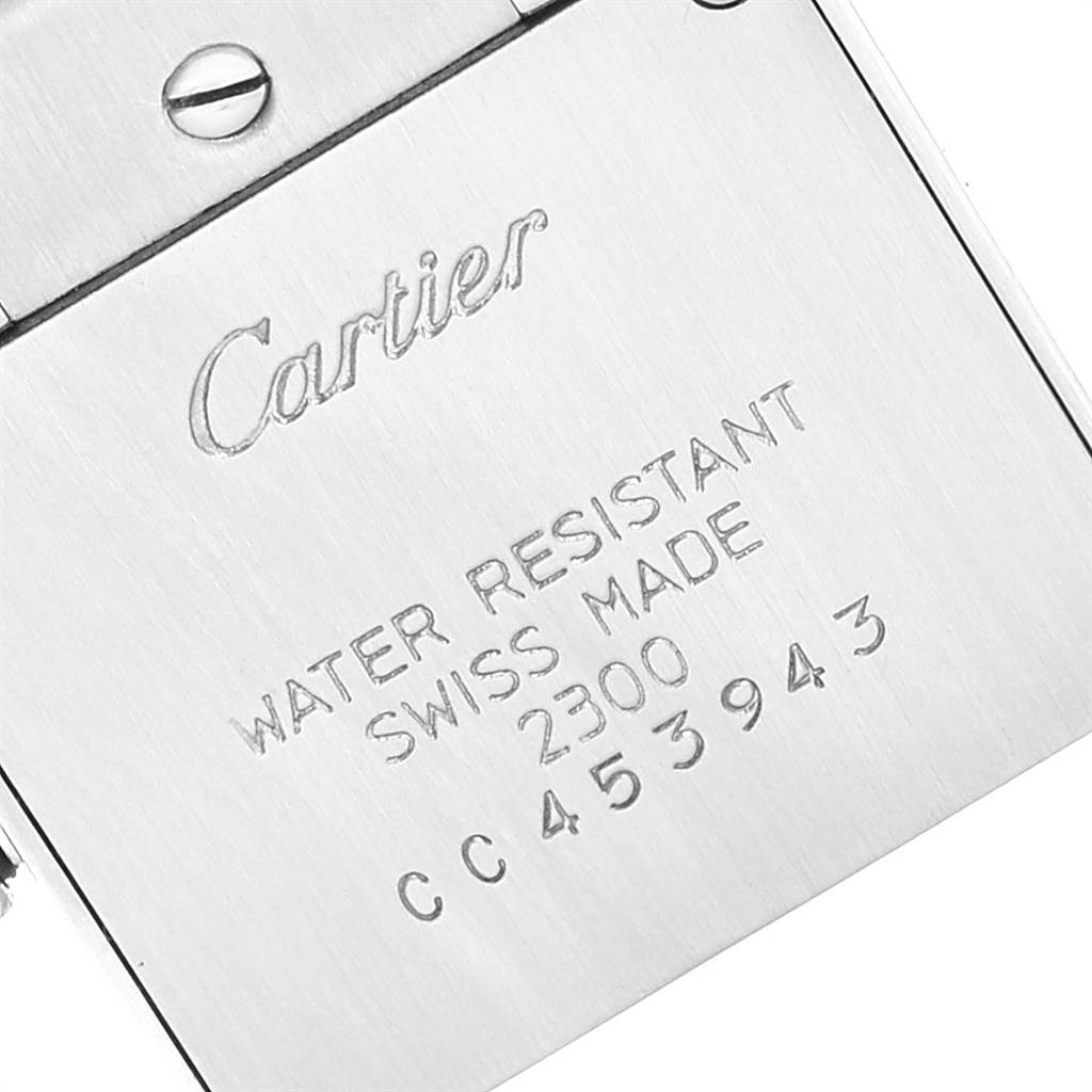 The image shows the back case of a Cartier Tank Francaise W51008Q3 Women
s Stainless Steel Silver Dial W51008Q3 Women
s Stainless Steel Silver Dial watch, displaying engraved text and a screw.