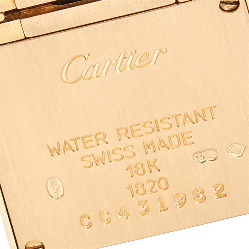 This image shows the engraved details on the back case of a Cartier Tank Francaise W50002N2 Women's Yellow Gold Silver Dial W50002N2 Women's Yellow Gold Silver Dial watch, including water resistance and material information.