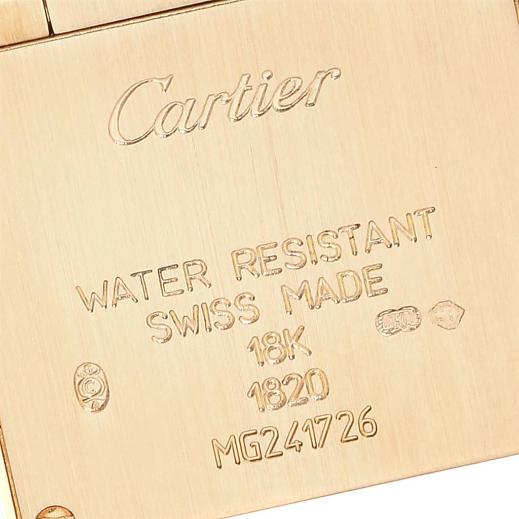 The image displays a close-up of the back side of the Tank Francaise watch by Cartier, showcasing engravings and the serial number.
