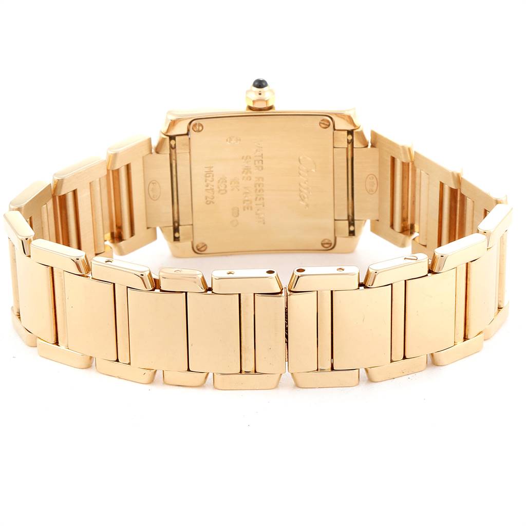 The image shows the back and the bracelet of a Cartier Tank Française watch with a focus on the gold links and caseback.