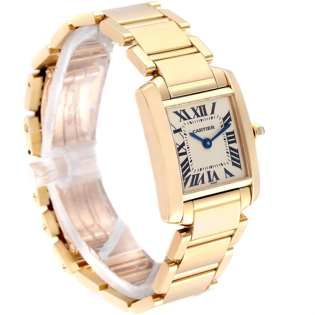 The Cartier Tank Française watch is shown at a three-quarter angle, highlighting its gold bracelet and distinctive rectangular dial.