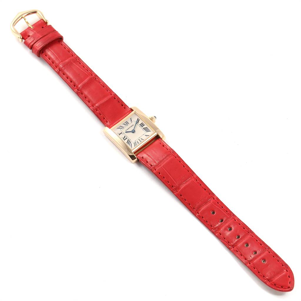 The image shows a Cartier Tank Francaise W5000256 Women's Yellow Gold Silver Dial W5000256 Women's Yellow Gold Silver Dial watch with a red leather strap, viewed from above.