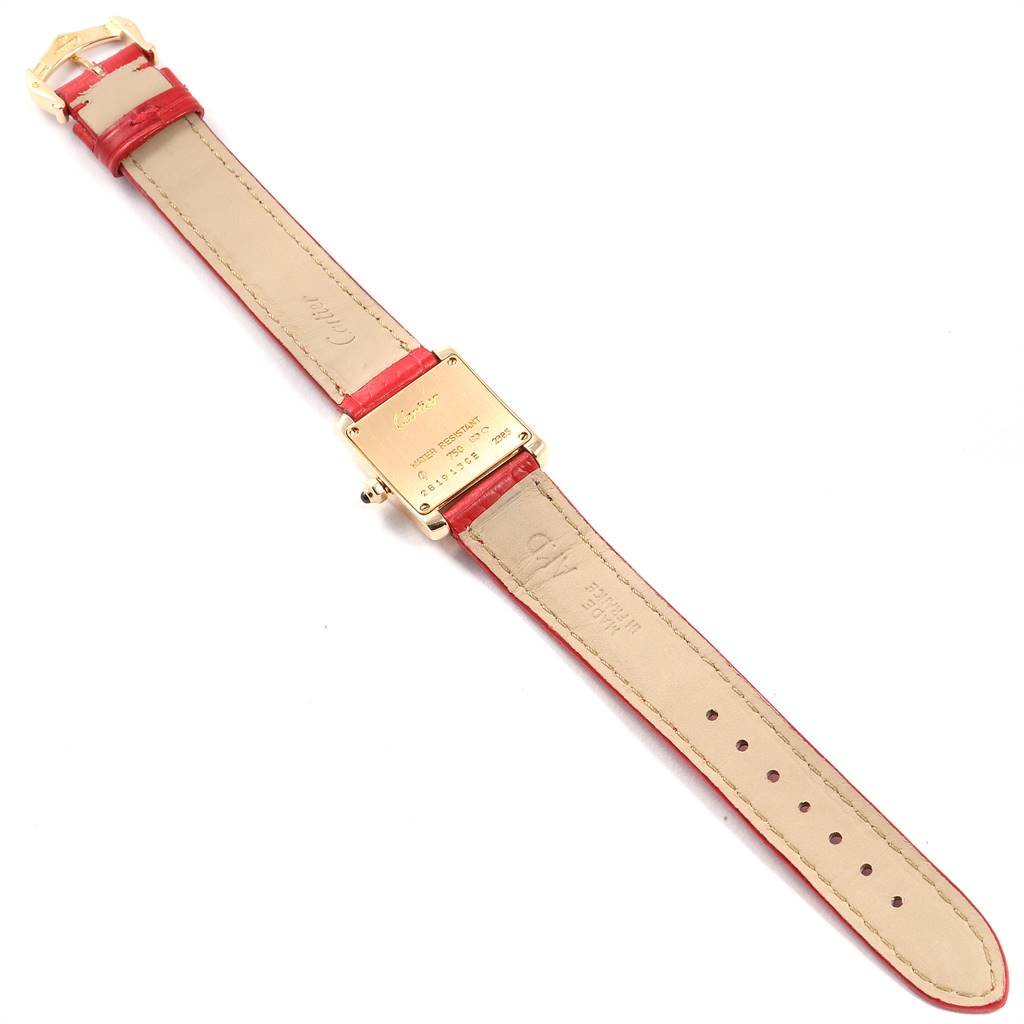 The image shows the back view of a Cartier Tank Francaise W5000256 Women's Yellow Gold Silver Dial W5000256 Women's Yellow Gold Silver Dial watch with a red leather strap fully extended.