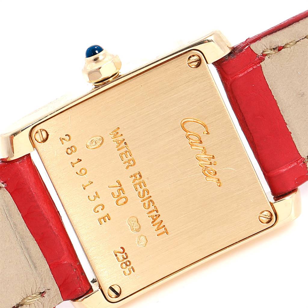 The image shows the back case of a Cartier Tank Francaise W5000256 Women's Yellow Gold Silver Dial W5000256 Women's Yellow Gold Silver Dial watch with a red strap and visible engravings.