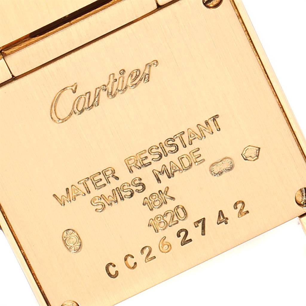 The image shows the back of the Cartier Tank Francaise W50002N2 Women's Yellow Gold Silver Dial W50002N2 Women's Yellow Gold Silver Dial watch, displaying inscriptions about water resistance, material, and Swiss origin.