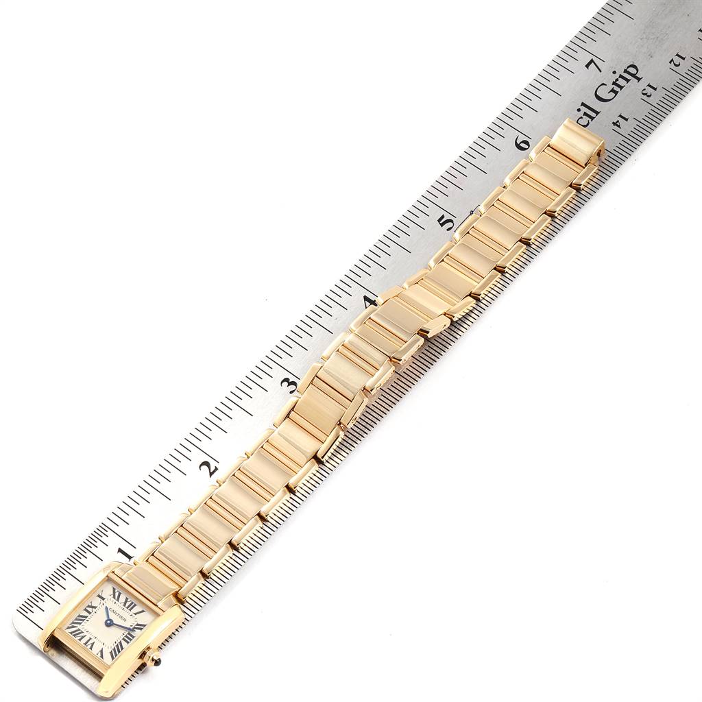 The image shows a Cartier Tank Francaise W50002N2 Women's Yellow Gold Silver Dial W50002N2 Women's Yellow Gold Silver Dial watch laid flat next to a ruler for measurement.