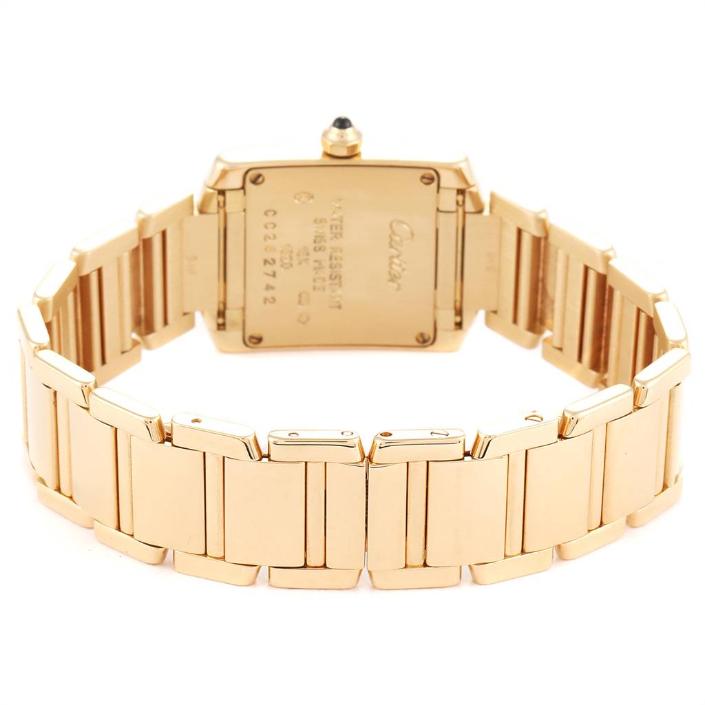 The image shows the back view of the Cartier Tank Française watch, highlighting the gold bracelet and case back.