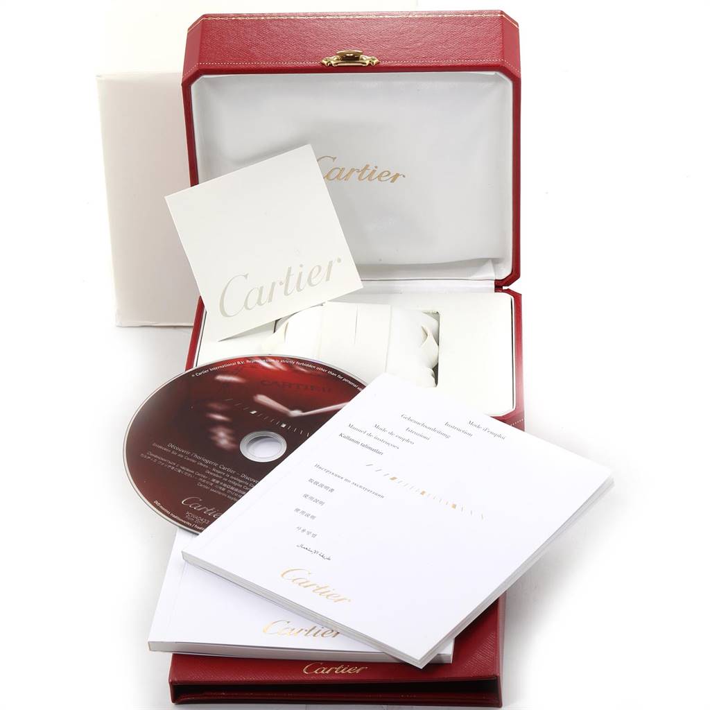 The image shows accessories for a Cartier Tank Francaise W51007Q4 Women's Steel and Gold (two tone) Silver Dial W51007Q4 Women's Steel and Gold (two tone) Silver Dial watch, including a red box, manual, CD, warranty card, and cushion.