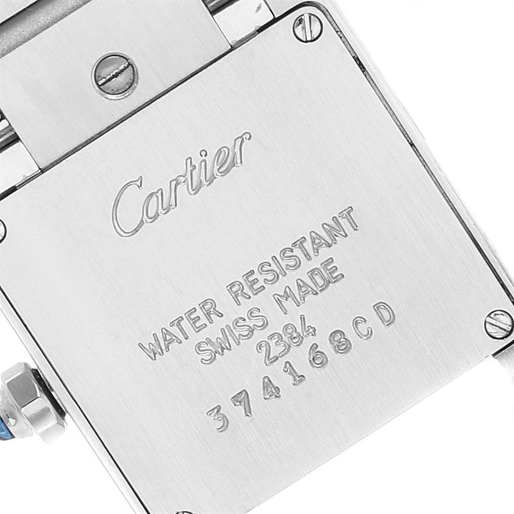 The image shows the case back of a Cartier Tank Francaise W51008Q3 Women's Stainless Steel Silver Dial W51008Q3 Women's Stainless Steel Silver Dial watch, highlighting the engraved details.