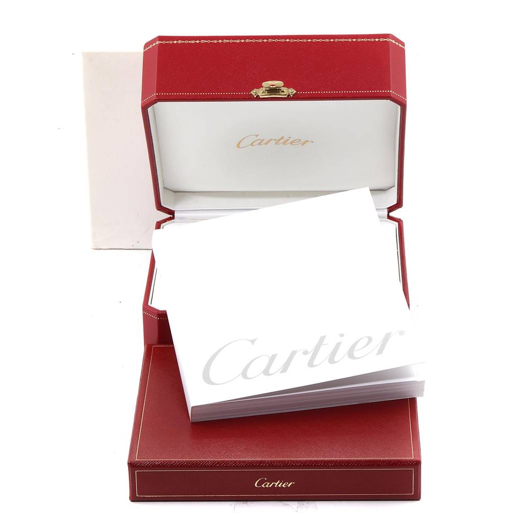 The image shows the packaging and documentation for a Cartier Tank Française watch, including a red box and manual.